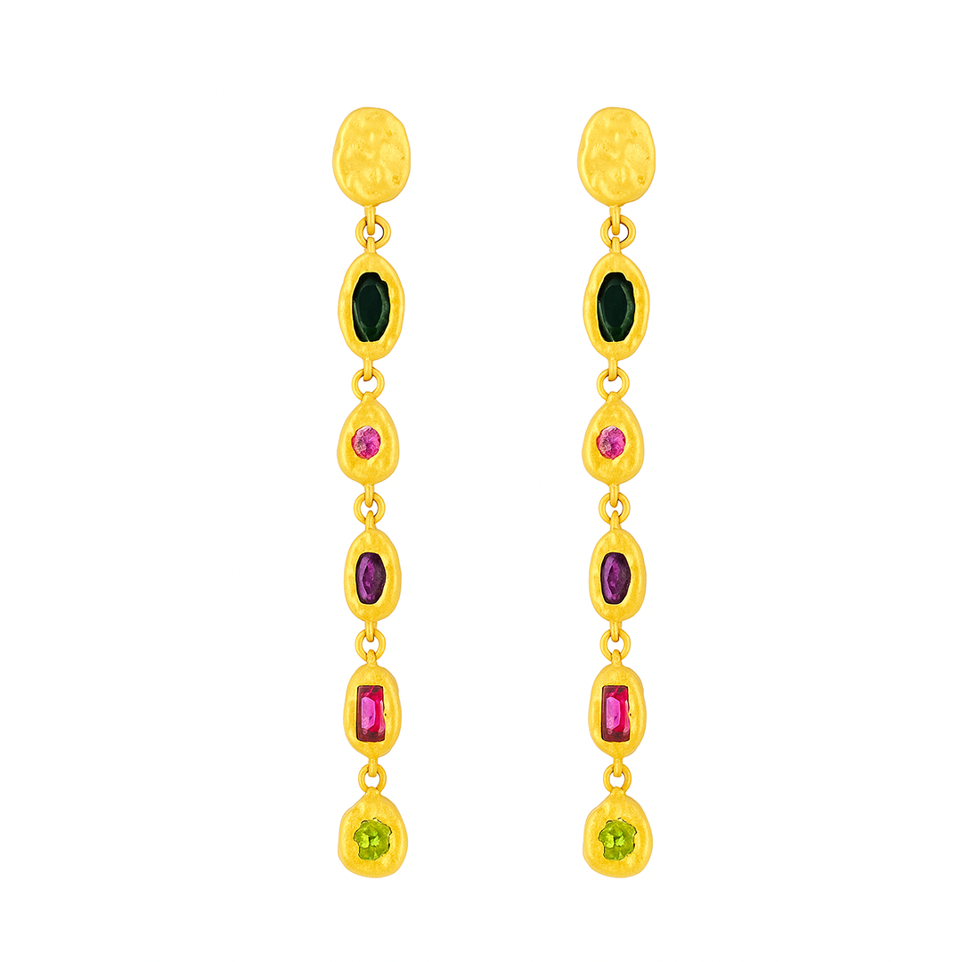 Gold earrings with colored gemstones on a white background