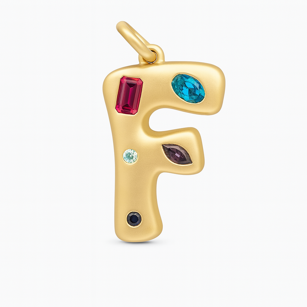 Gold letter 'F' pendant with colorful gemstones on a white background