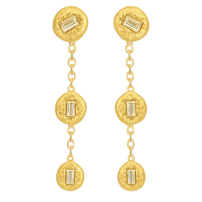 Gold earrings with circular designs and baguette gemstones on a white background