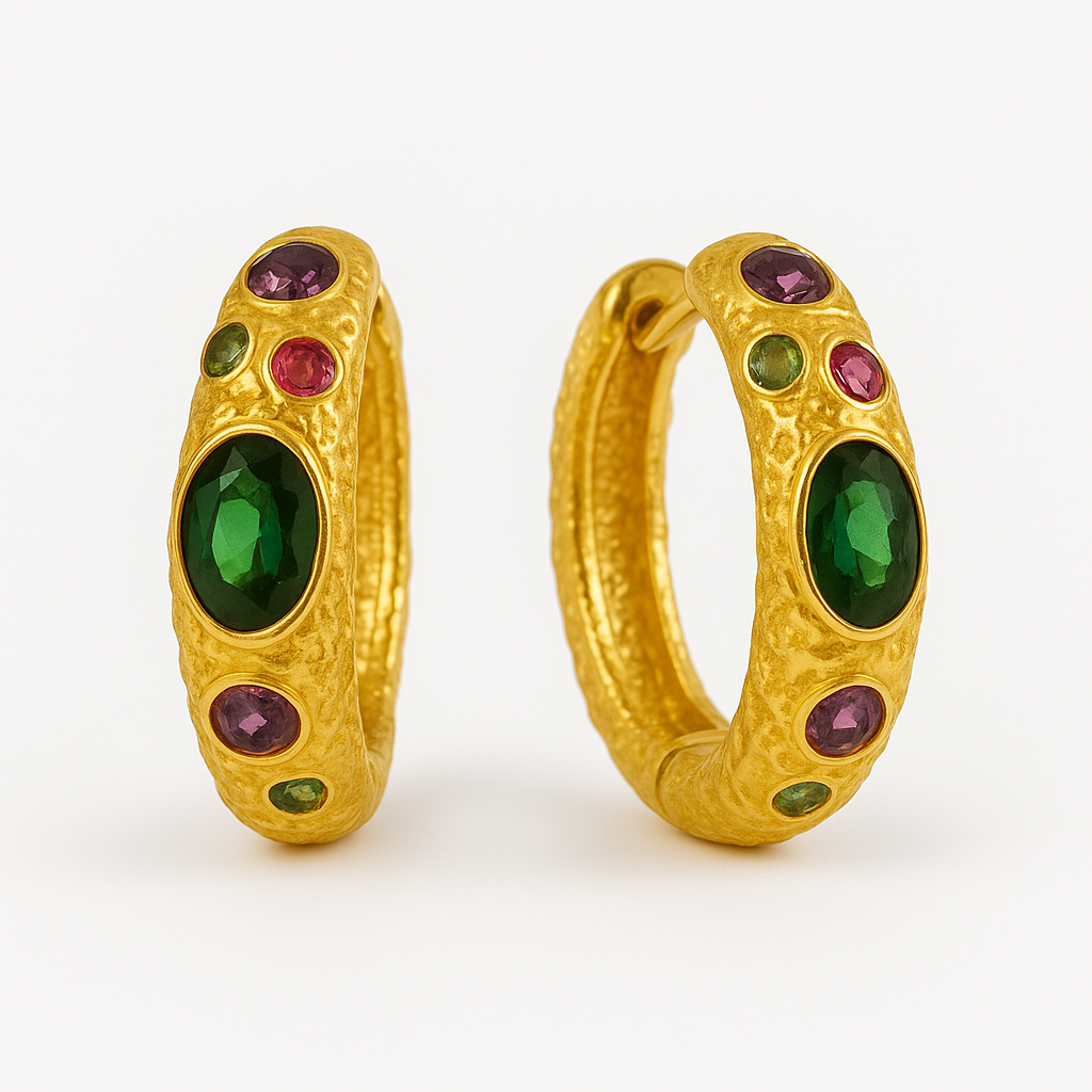 Gold hoop earrings with green and red gemstones on a white background