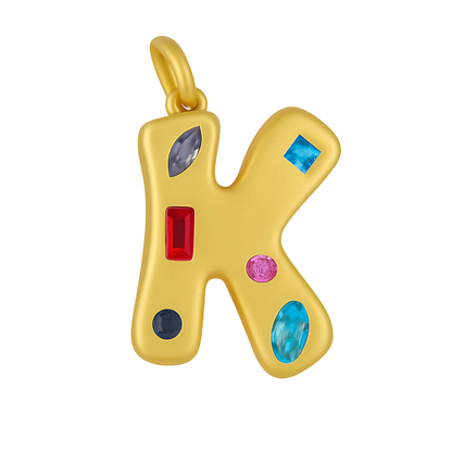Gold pendant shaped like the letter 'K' with colorful gemstones on a white background