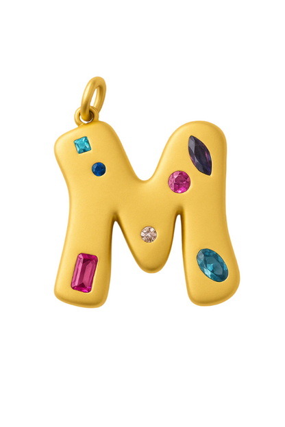 Gold letter 'M' pendant with colorful gemstones on a white background