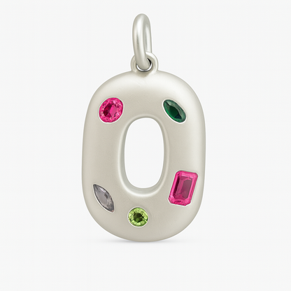 Silver O shaped pendant with colorful gemstones on a white background