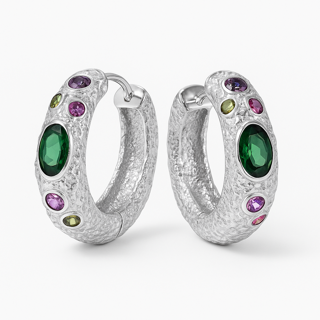 Silver hoop earrings with green and purple gemstones on a white background