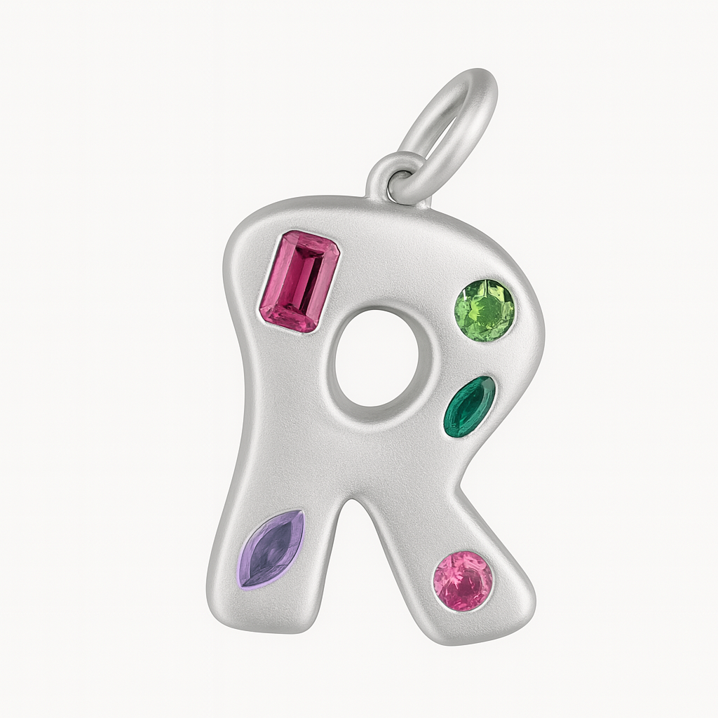 Silver R shaped pendant with colorful gemstones on a white background