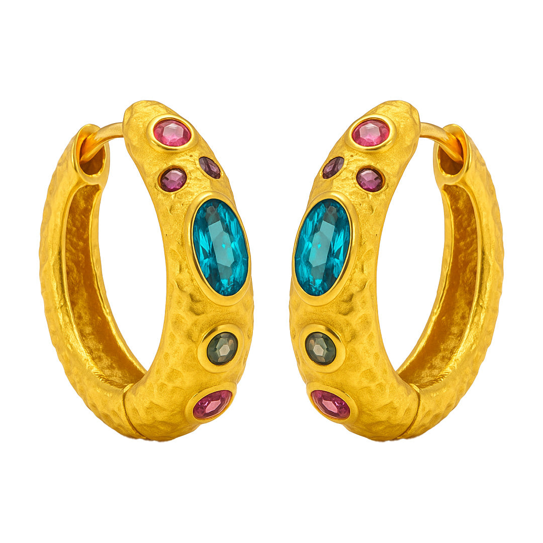 Gold hoop earrings with blue and pink gemstones on a white background