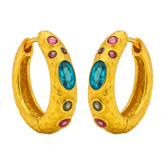 Gold hoop earrings with blue and pink gemstones on a white background