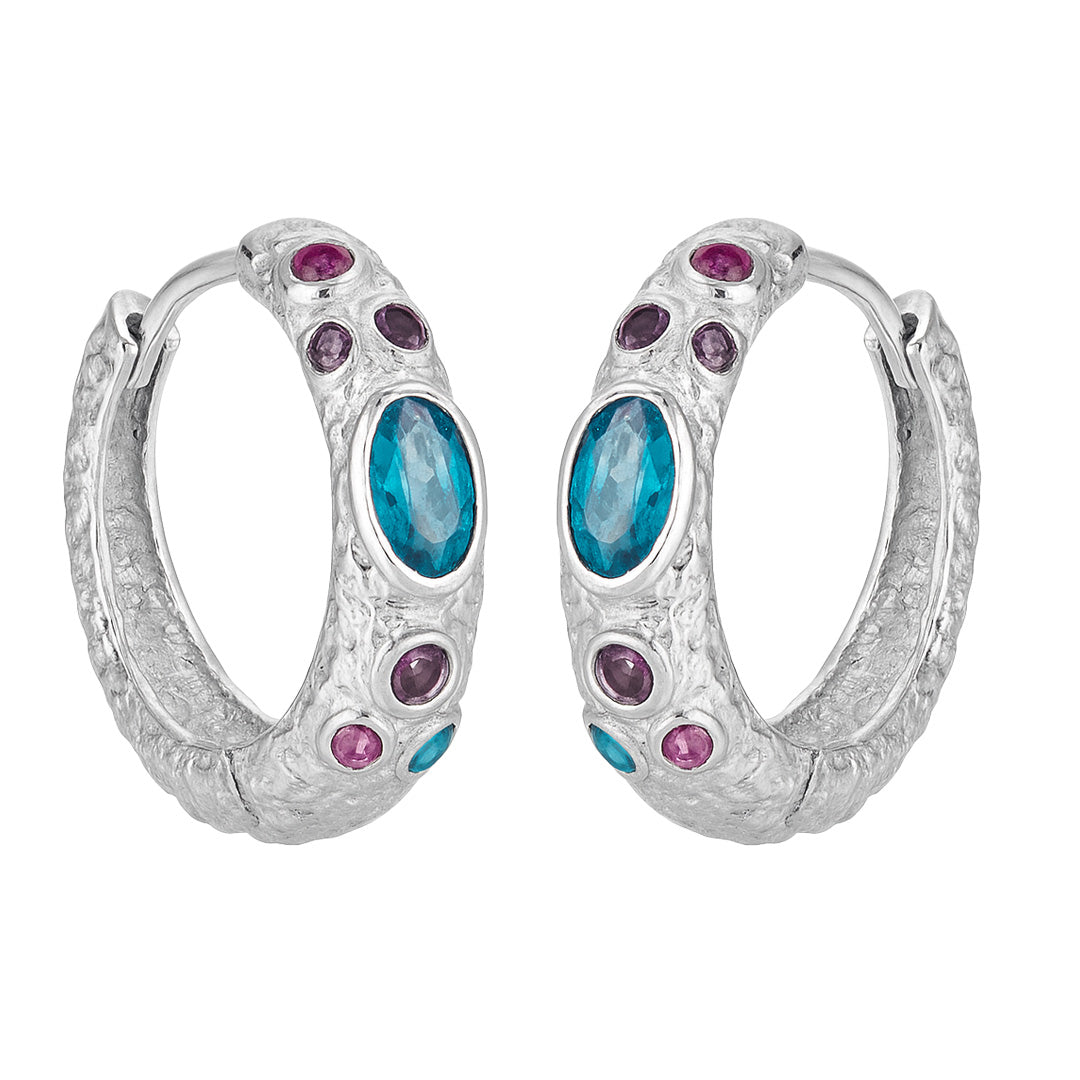 Silver hoop earrings with blue and purple gemstones on a white background