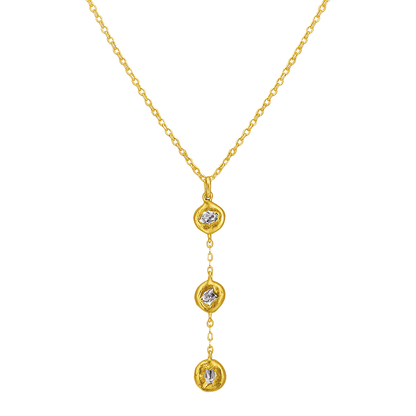 Gold necklace with three diamond pendants on a white background